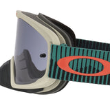 Oakley Oframe goggles with a beige frame, dark gray mirrored lens, and a green and black striped strap featuring a red Oakley logo.